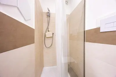 a shower with a glass door in a bathroom at Lampionelli 12 Apartment in Palermo