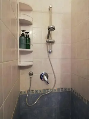 a shower with a shower head in a bathroom at Bellammari Holiday House in Palermo