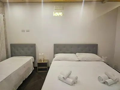 two beds in a room with towels on them at Duomo Suite - A Step from the Cathedral in Monreale