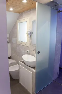 a bathroom with a sink and a toilet and a mirror at Duomo Suite - A Step from the Cathedral in Monreale