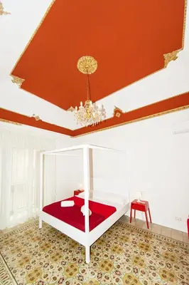 a white bed in a room with a red ceiling at Visitsicilia Donn'Anna in Castellammare del Golfo