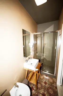 a bathroom with a sink and a shower and two toilets at Visitsicilia Donn'Anna in Castellammare del Golfo
