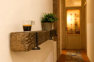 a cup of coffee on a wall next to a door at AthaHome Deluxe in Palermo
