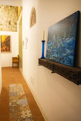 a hallway with a painting hanging on a wall at AthaHome Deluxe in Palermo