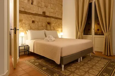 a bedroom with a bed with two towels on it at AthaHome Deluxe in Palermo