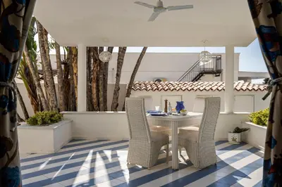 a patio with a table and chairs on a porch at Villa Angela By DomuSicily in Capaci