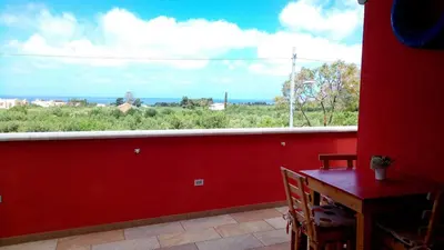 a red room with a table and a large window at B&B Albatros in Castelluzzo