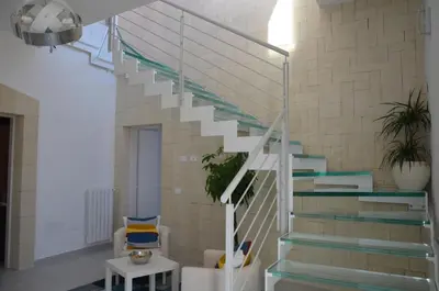 a staircase in a living room with blue and white stairs at B&B Albatros in Castelluzzo