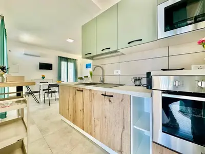 a kitchen with a sink and a stove at Sea Life Giulia, spiaggia a 200 mt in Alcamo Marina