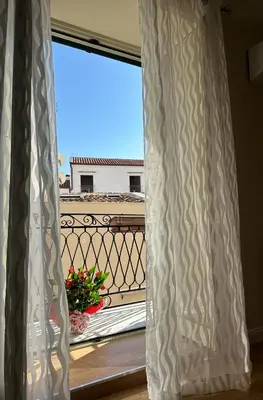 a window with a view of a balcony at Mart Rental Apartament in Palermo