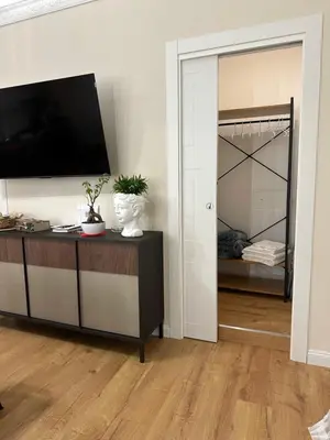 a living room with a tv on a wall at Mart Rental Apartament in Palermo