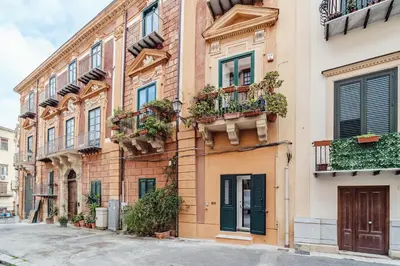 an apartment building with balconies on a street at N'amuri in Palermo