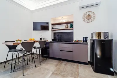 a kitchen with a black refrigerator and a table at N'amuri in Palermo