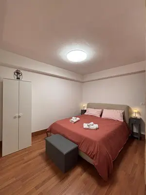 a bedroom with a bed with two towels on it at Houel's House in Palermo