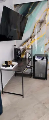 a table in a room with a microwave at The Moon Suite in Palermo