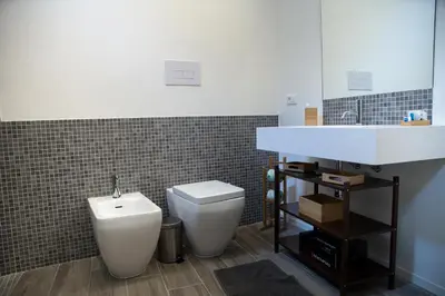 a bathroom with a toilet and a sink at Apartments Porta di Castro in Palermo