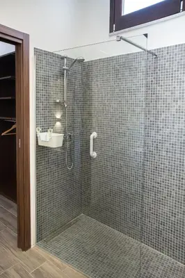 a bathroom with a glass shower with a sink at Apartments Porta di Castro in Palermo