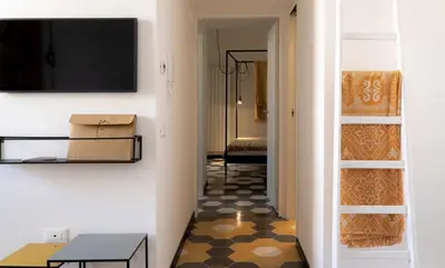 a hallway with a room with a television and a table at Il Moro & La Dama in Palermo