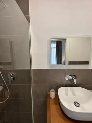 a bathroom with a sink and a shower at Historic Palazzo - Apartments & Rooms with Private Bathroom in Palermo