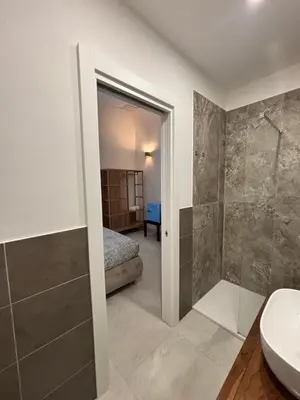 a bathroom with a shower and a toilet and a sink at Historic Palazzo - Apartments & Rooms with Private Bathroom in Palermo