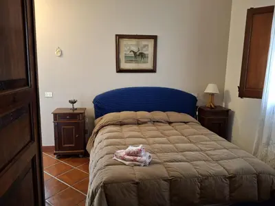 a bedroom with a bed with a doll on it at The Green Planet in Balestrate