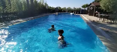 two children swimming in a swimming pool at The Green Planet in Balestrate