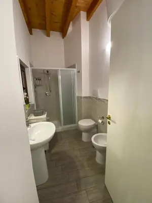 a bathroom with two toilets and a shower and a sink at White House Theater Massimo in Palermo
