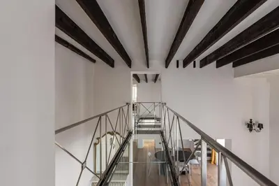 a staircase in a white building with wooden beams at Appartamento Sammartino by Wonderful Italy in Palermo