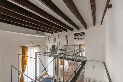 a glass staircase in a room with wooden ceilings at Appartamento Sammartino by Wonderful Italy in Palermo