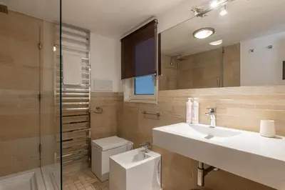 a bathroom with a sink and a toilet and a mirror at Appartamento Sammartino by Wonderful Italy in Palermo