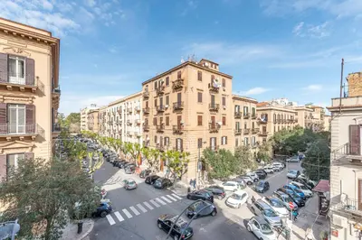 a city street with cars parked in front of buildings at Appartamento Sammartino by Wonderful Italy in Palermo