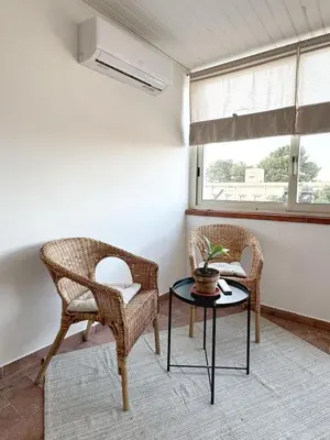 a room with two chairs and a table and a window at Casa Ragonese in Palermo