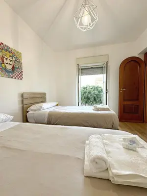 a bedroom with two beds and a window at Casa Ragonese in Palermo