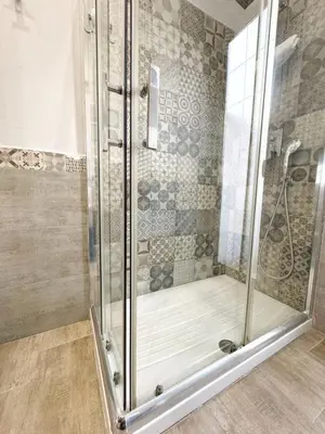 a shower with a glass door in a bathroom at Casa Ragonese in Palermo