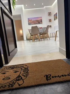 a living room with a table and chairs and a rug at A Casa di Giro suite apartment in Palermo