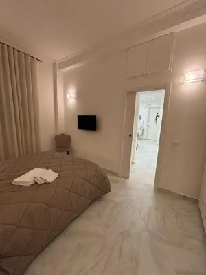 a bedroom with a bed and a tv on the wall at A Casa di Giro suite apartment in Palermo