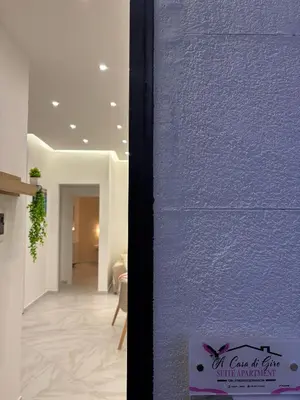 a room with a purple wall and a hallway at A Casa di Giro suite apartment in Palermo