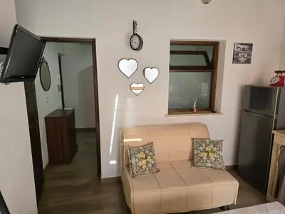 a living room with a couch and hearts on the wall at Casa Vacanza Isola di Eufemio in Capaci