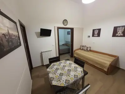 a bedroom with a bed and a table and a clock at Casa Vacanza Isola di Eufemio in Capaci