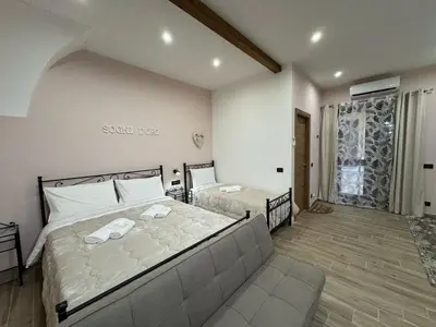 a bedroom with a large bed and a couch at Sogni D'oro 01 in Partinico