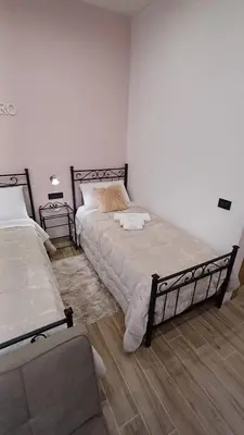 a bedroom with two beds and two night stands at Sogni D'oro 01 in Partinico