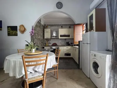 a bedroom with a large bed with a stone wall at Casa Albachiara in Borgetto