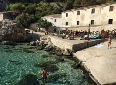 a villa with a swimming pool and two chairs at Villa Paradise Luxury in Castellammare del Golfo
