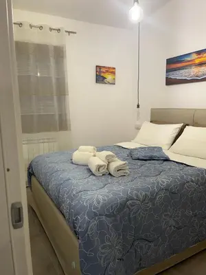 a bedroom with a bed and a painting on the wall at Villa Paradise Luxury in Castellammare del Golfo