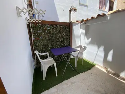 a small table and two chairs on a balcony at Le Ortensie Appartamento Grande in San Vito lo Capo