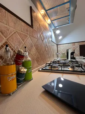 a kitchen counter with a coffee maker and glasses on a towel at A Casa Da Mari' in Terrasini