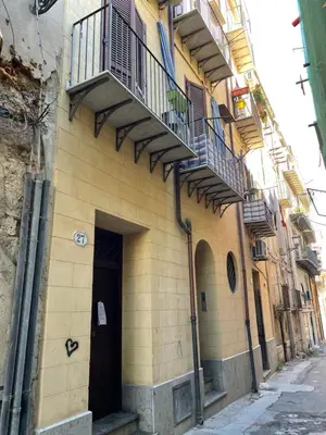 a building with stairs and balconies on the side of it at Appartamento Ciccio al Capo in Palermo