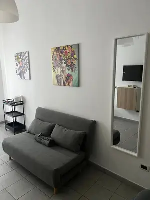 a living room with a couch and a mirror at Appartamento Ciccio al Capo in Palermo
