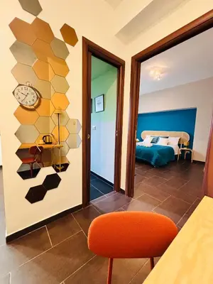 a room with a bed and a clock on the wall at Maison N 16 in Palermo