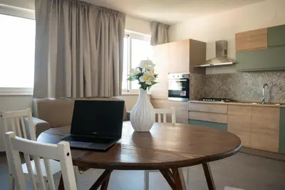 a laptop on a wooden table in a kitchen at Le Case del Massimo in centrocittà in Palermo